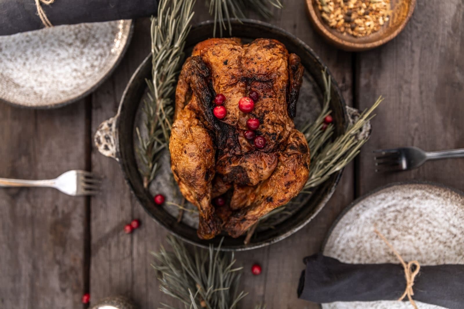 Roasted turkey with cranberries and rosemary on a Thanksgiving table